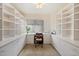 Office with custom cabinetry, desk, and a large window at 63 W Los Arboles Dr, Tempe, AZ 85284
