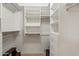 Walk-in closet with custom shelving and drawers at 63 W Los Arboles Dr, Tempe, AZ 85284