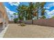 Desert-landscaped backyard featuring privacy wall, mature trees, and cacti at 6372 S Callaway Dr, Chandler, AZ 85249