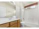A well-lit bathroom with a single vanity, tile flooring, and a tub with shower at 6372 S Callaway Dr, Chandler, AZ 85249
