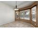 Dining area with large windows bringing in natural light and a stylish light fixture at 6372 S Callaway Dr, Chandler, AZ 85249
