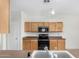 Bright kitchen with wooden cabinets and a black microwave oven at 6372 S Callaway Dr, Chandler, AZ 85249