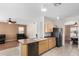 Open kitchen and living area with modern appliances, wood cabinets, and tile flooring at 6372 S Callaway Dr, Chandler, AZ 85249