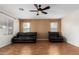 Comfortable living room with two large windows, ceiling fan and laminate flooring at 6372 S Callaway Dr, Chandler, AZ 85249