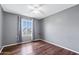 A gray-walled bedroom featuring a window, ceiling fan, and wood-look flooring at 742 E Garnet Ave, Mesa, AZ 85204