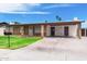Charming single-story brick home featuring a covered carport and well-maintained front yard at 742 E Garnet Ave, Mesa, AZ 85204