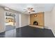 Inviting living room with a brick fireplace, ceiling fan, and sliding door access to the pool at 742 E Garnet Ave, Mesa, AZ 85204