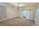 A spacious room with a modern chandelier and a sliding barn door to the main bathroom at 7531 E Billings St # 123, Mesa, AZ 85207