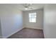 Empty bedroom features neutral colors, a ceiling fan, and a window with plenty of natural light at 7531 E Billings St # 123, Mesa, AZ 85207