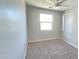 A bright bedroom with large windows and plush carpeting, awaiting personal touches at 7531 E Billings St # 123, Mesa, AZ 85207