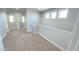 Upstairs hallway featuring neutral carpet, white walls, and natural light at 7531 E Billings St # 123, Mesa, AZ 85207
