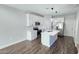 Modern kitchen equipped with stainless steel appliances, white cabinets and a center island at 7531 E Billings St # 123, Mesa, AZ 85207