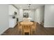 Charming kitchen features white cabinets, an island with pendant lights, and wood floors at 7531 E Billings St # 123, Mesa, AZ 85207