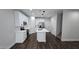 Kitchen area featuring stainless steel appliances, white cabinets, a center island and wood flooring at 7531 E Billings St # 123, Mesa, AZ 85207