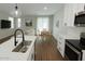 Open-concept kitchen flows into the living area with wood floors and natural light at 7531 E Billings St # 123, Mesa, AZ 85207