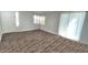 Spacious living room features wood floors, large windows, and natural light at 7531 E Billings St # 123, Mesa, AZ 85207
