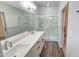 Bathroom featuring dual sinks, white countertops, framed mirror and glass enclosed shower at 7531 E Billings St # 123, Mesa, AZ 85207