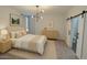 This is a view of the main bedroom with a king bed and barn door leading to the bathroom at 7531 E Billings St # 123, Mesa, AZ 85207