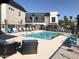Community pool with lounge seating and modern townhome buildings at 7531 E Billings St # 123, Mesa, AZ 85207