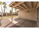 Covered back patio with concrete flooring, gravel landscaping, and views of the grassy yard at 763 E Park Ave, Chandler, AZ 85225