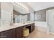 Stylish bathroom with a double vanity, a soaking tub, a glass-enclosed shower, and walk-in closet at 763 E Park Ave, Chandler, AZ 85225