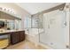 Elegant bathroom featuring a soaking tub, a glass-enclosed shower, and a vanity at 763 E Park Ave, Chandler, AZ 85225