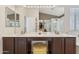 Primary bathroom with dual sinks, a vanity, large mirror, and walk-in closet for ample storage at 763 E Park Ave, Chandler, AZ 85225