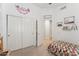 Cozy bedroom with large closet, neutral carpet, and a cheerful, colorful quilt at 763 E Park Ave, Chandler, AZ 85225