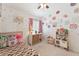 Bright bedroom featuring a ceiling fan, floral decorations, and a cute ' kitchen at 763 E Park Ave, Chandler, AZ 85225