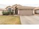 Inviting home exterior with a two-car garage, desert landscaping, and a tiled roof at 763 E Park Ave, Chandler, AZ 85225