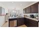 Modern kitchen with granite countertops, stainless steel appliances, and dark wood cabinetry at 763 E Park Ave, Chandler, AZ 85225