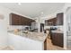 Modern kitchen with granite countertops, stainless steel appliances, and dark wood cabinets at 763 E Park Ave, Chandler, AZ 85225
