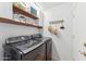 Laundry area with modern washer and dryer, floating shelves, and wall decor at 763 E Park Ave, Chandler, AZ 85225