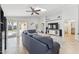 Living room with large sectional sofa, tile flooring, skylight, and direct access to the backyard at 763 E Park Ave, Chandler, AZ 85225