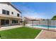 Well manicured backyard with pool, synthetic grass lawn, and covered patio, perfect for entertaining at 7869 W Market St, Glendale, AZ 85303