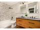Beautiful bathroom with double vanity, wood-look floors, and decorative tile accents and marble countertops at 7869 W Market St, Glendale, AZ 85303