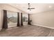 Spacious bedroom with high ceilings, wood floors, ceiling fan, and large windows at 7869 W Market St, Glendale, AZ 85303