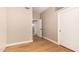 An airy bedroom features light walls, a door to a closet, and warm, wood-look floors at 7869 W Market St, Glendale, AZ 85303