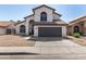 Charming two-story home with an arched entry, tile roof, desert landscaping, and a two car garage at 7869 W Market St, Glendale, AZ 85303