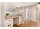 Bright hallway with wood floors and built-in desk with white cabinets and drawers at 7869 W Market St, Glendale, AZ 85303