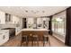 Modern kitchen with quartz counters, stainless steel appliances, and wood-accented island seating at 7869 W Market St, Glendale, AZ 85303