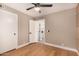 Bright bedroom with view to laundry room featuring wood floors, recessed lighting, and neutral paint at 7869 W Market St, Glendale, AZ 85303