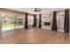Bright living room featuring tiled floors, a corner fireplace, big windows, and sliding glass doors at 7869 W Market St, Glendale, AZ 85303