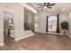 Open-concept living room with soaring ceilings, modern chandelier, wood-look tile floors, and staircase at 7869 W Market St, Glendale, AZ 85303