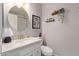 Bathroom featuring a round mirror, a vanity, and a shelf with plants at 8140 N 107Th Ave # 142, Peoria, AZ 85345