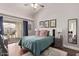 Bright bedroom with a ceiling fan, balcony access, a comfortable bed, and stylish decor at 8140 N 107Th Ave # 142, Peoria, AZ 85345
