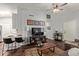 Cozy living room with dark wood floors and views to barstool seating at 8140 N 107Th Ave # 142, Peoria, AZ 85345