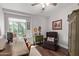 Comfortable home office with a large window, desk, chair, and cozy reading nook with a cushioned chair at 8140 N 107Th Ave # 142, Peoria, AZ 85345