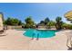Resort-style community pool surrounded by palm trees and lounge chairs, great for relaxation and recreation at 8140 N 107Th Ave # 142, Peoria, AZ 85345