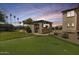 Lush backyard oasis with a built-in kitchen, putting green, and ample space for recreation at 890 W Zion Pl, Chandler, AZ 85248